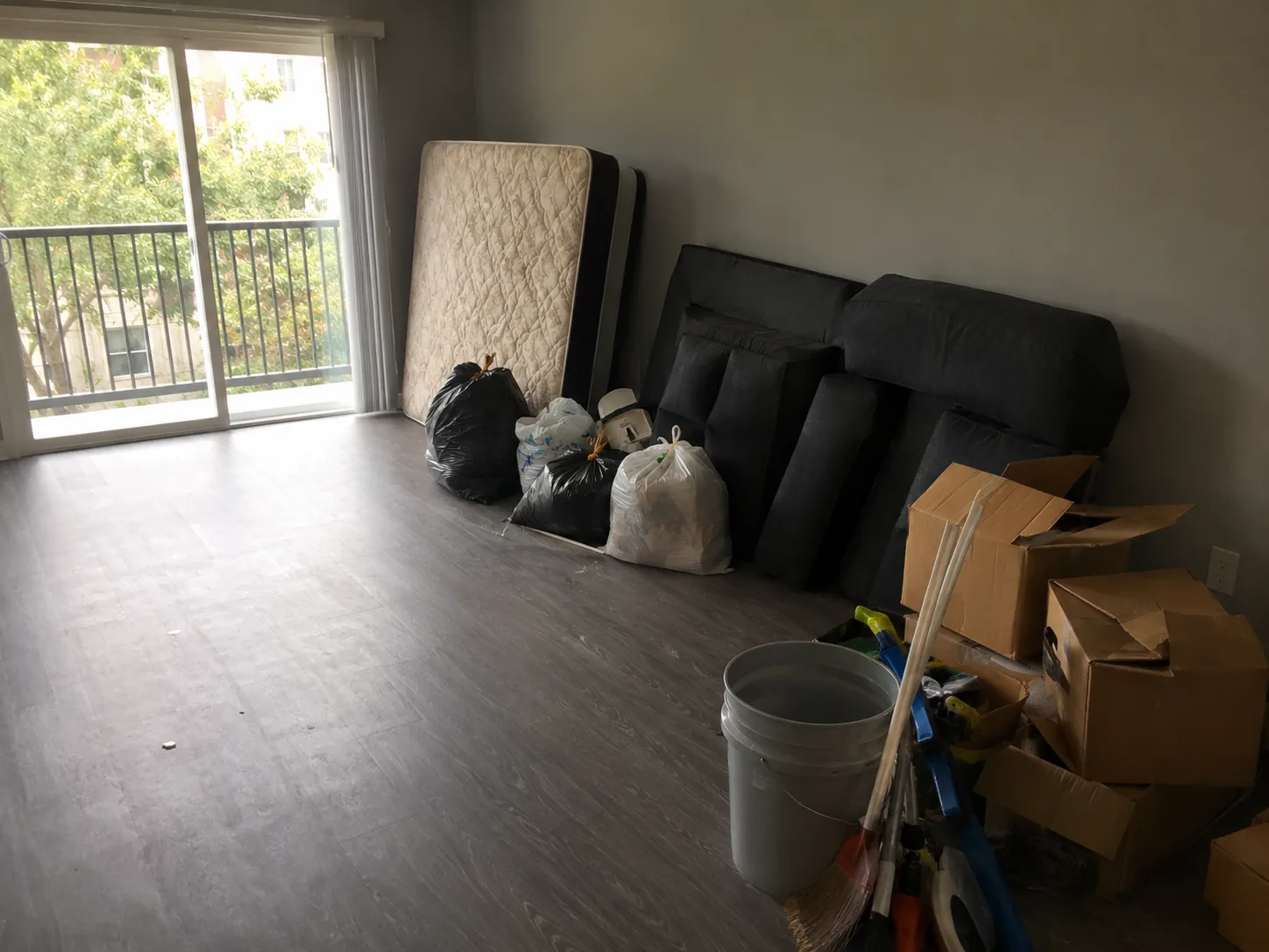 Empty Dallas apartment with a mattress, bags and boxes left behind